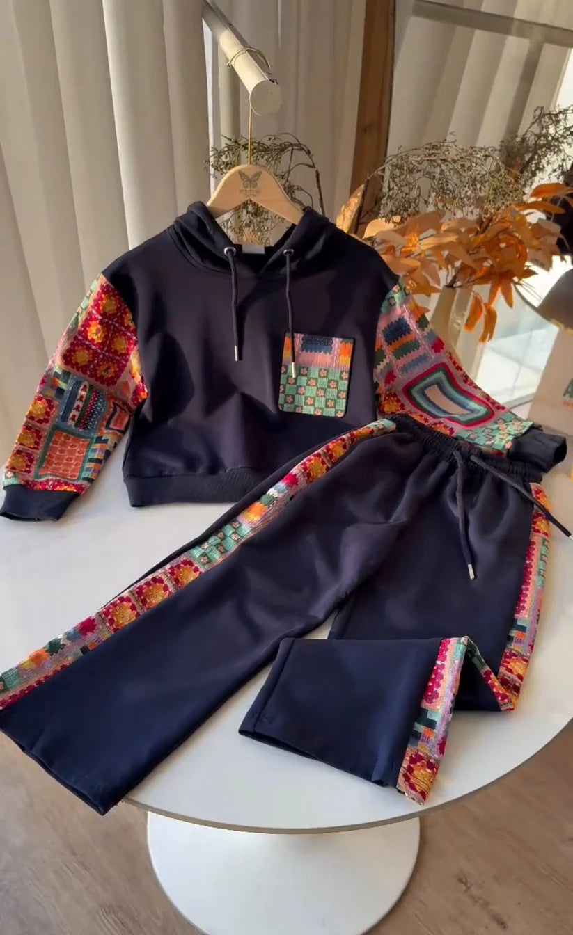 Navy tracksuit with colorful sleeves and drawstring on a white surface.