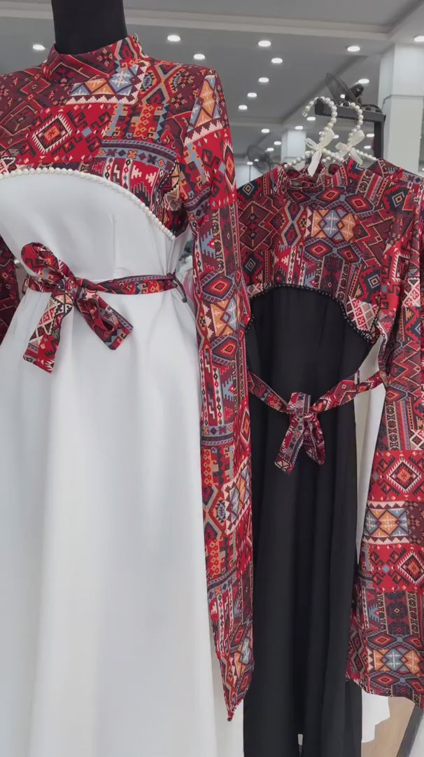 Long black dress with a red and blue geometric pattern on the bodice and wide sleeves, featuring a matching waist belt tied in a bow 04