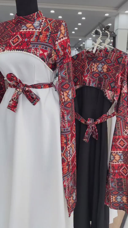 Long black dress with a red and blue geometric pattern on the bodice and wide sleeves, featuring a matching waist belt tied in a bow 04